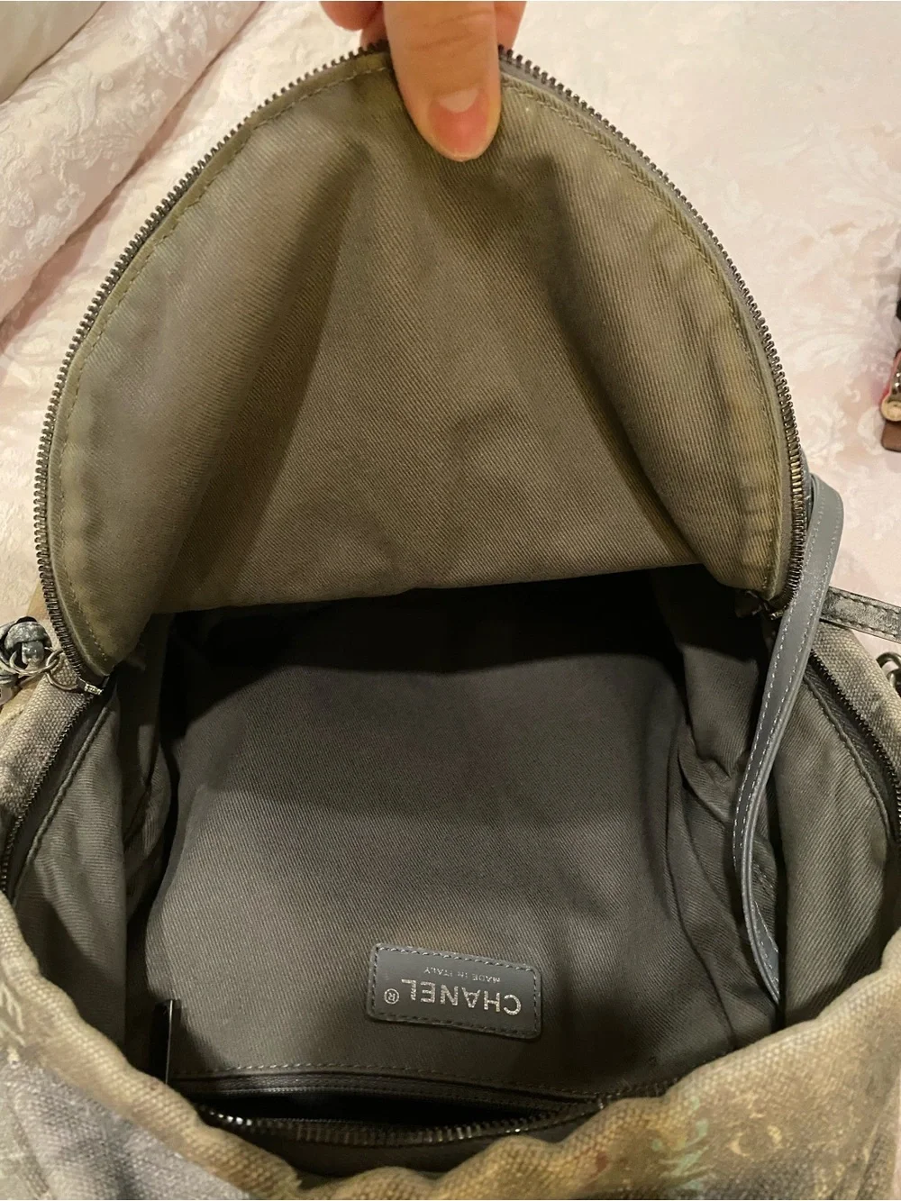 CHANEL Faded Beige Canvas Backpack with Multicolor Strap and Silver-Tone Charm